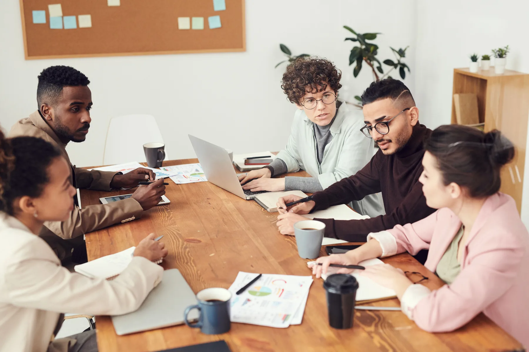 Business team planning a connected technology strategy around a table.